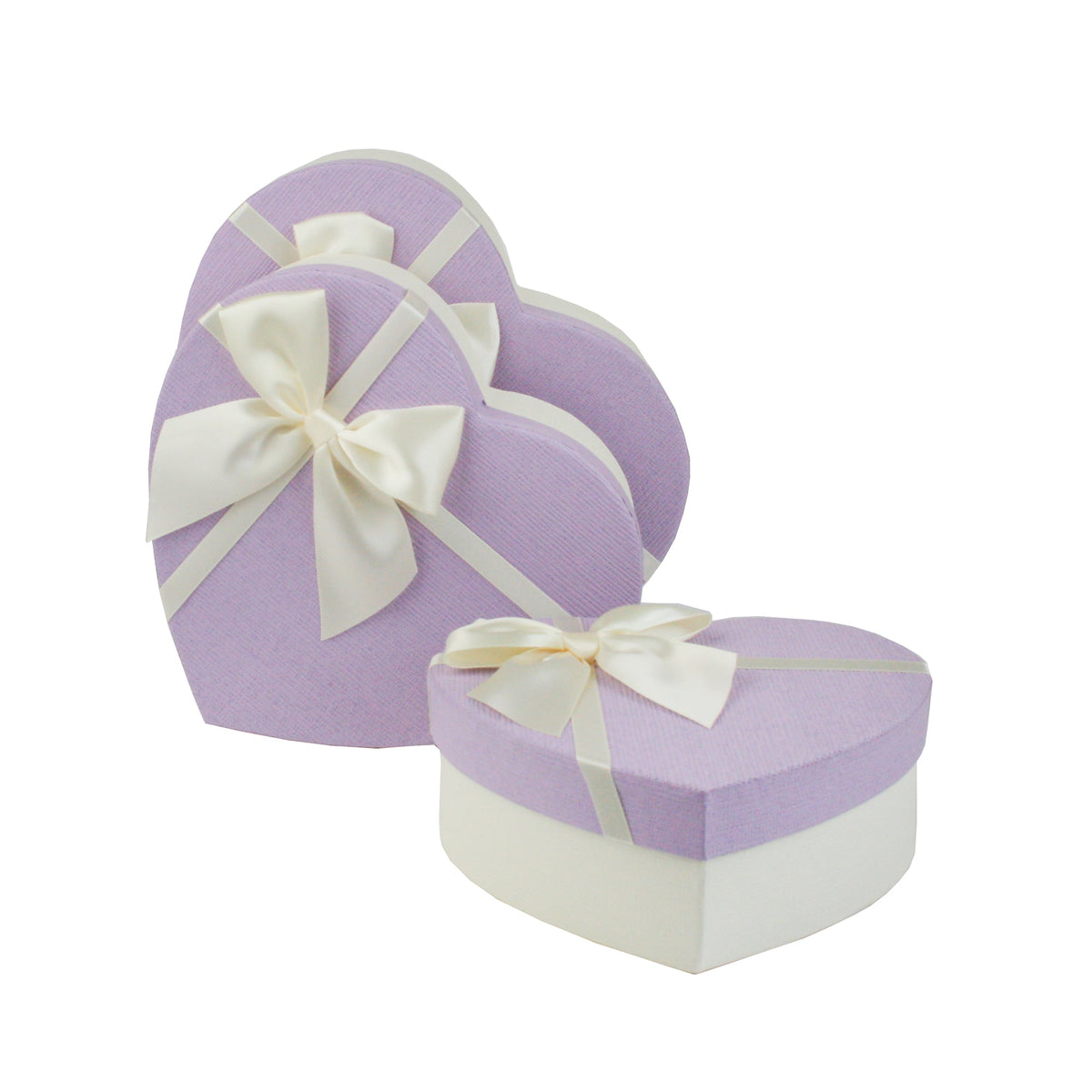 Heart shaped white and lilac gift boxes with ribbon bows